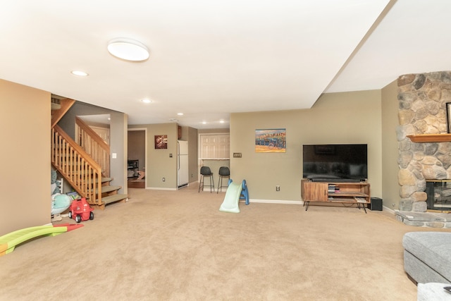 70 Chestnut Ct, Chelsea, MI 48118 - carpeted living room featuring stairway, recessed lighting, a stone fireplace, and baseboards