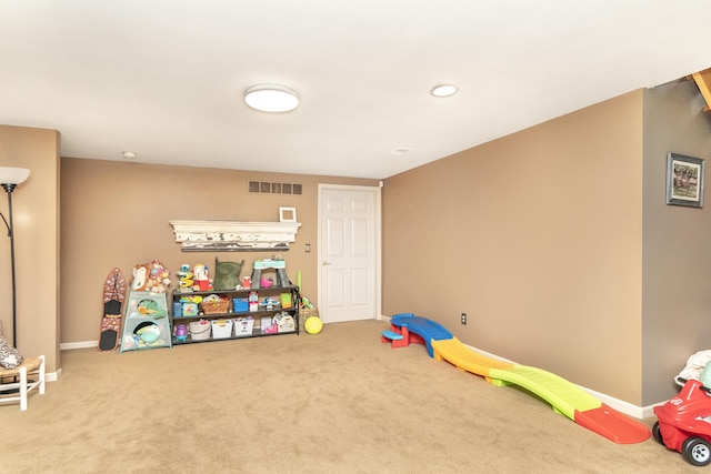 70 Chestnut Ct, Chelsea, MI 48118 - rec room with baseboards, visible vents, and carpet