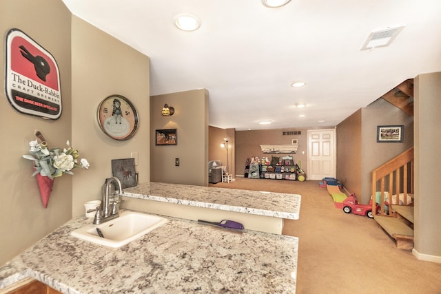 70 Chestnut Ct, Chelsea, MI 48118 - interior space featuring a sink, visible vents, recessed lighting, carpet, and a peninsula