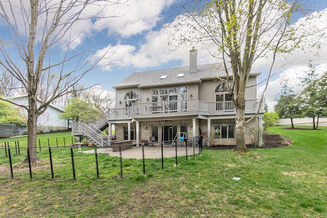 70 Chestnut Ct, Chelsea, MI 48118 - back of property featuring a patio, a wooden deck, a chimney, a lawn, and a fenced backyard