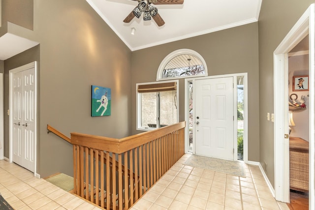 70 Chestnut Ct, Chelsea, MI 48118 - entrance foyer with crown molding, ceiling fan, baseboards, tile patterned floors, and a towering ceiling