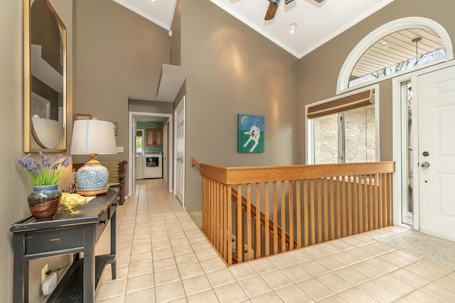 70 Chestnut Ct, Chelsea, MI 48118 - tiled entryway featuring high vaulted ceiling, washer / clothes dryer, a ceiling fan, and crown molding