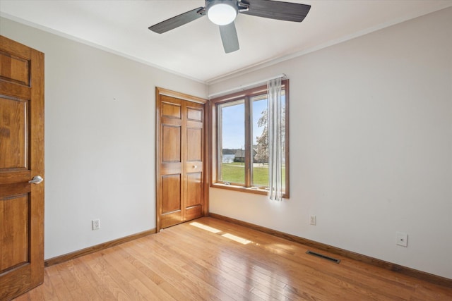 6030 Paw Paw Lake Rd, Coloma, MI 49038 - unfurnished bedroom featuring light wood-type flooring, ornamental molding, baseboards, and a ceiling fan