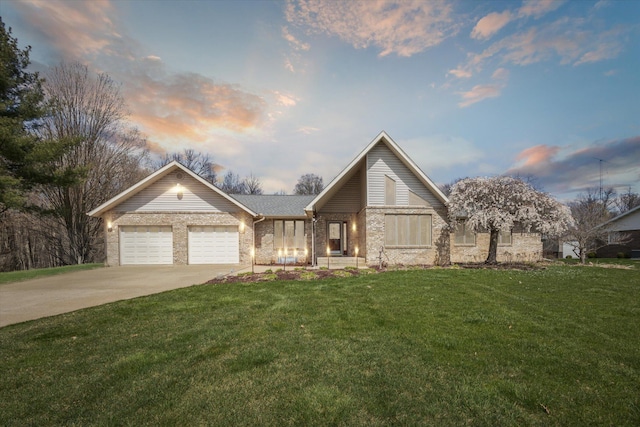 6030 Paw Paw Lake Rd, Coloma, MI 49038 - view of front facade featuring a garage, concrete driveway, brick siding, and a yard