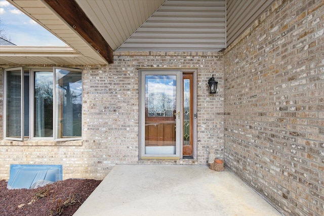 6030 Paw Paw Lake Rd, Coloma, MI 49038 - view of exterior entry with brick siding and a patio