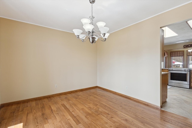 6030 Paw Paw Lake Rd, Coloma, MI 49038 - spare room featuring a chandelier, light wood-style floors, baseboards, and crown molding