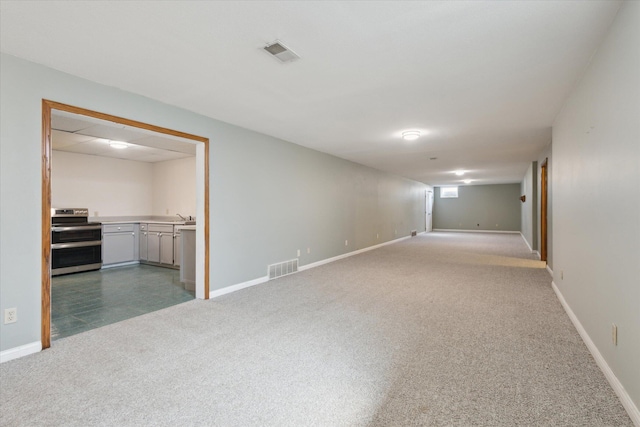 6030 Paw Paw Lake Rd, Coloma, MI 49038 - empty room featuring carpet, a sink, and baseboards