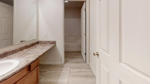 bathroom with baseboards and vanity