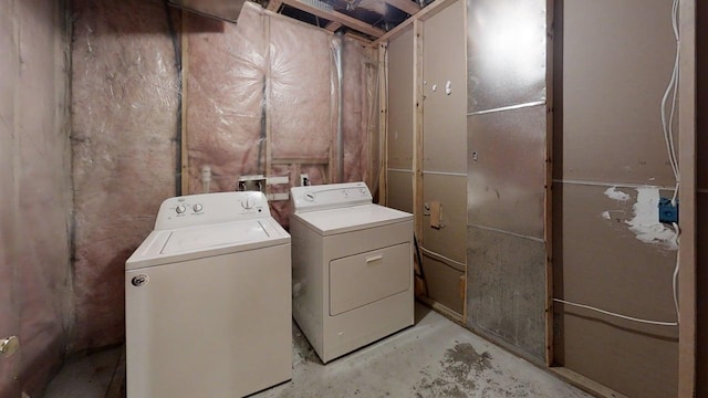 clothes washing area featuring independent washer and dryer and laundry area