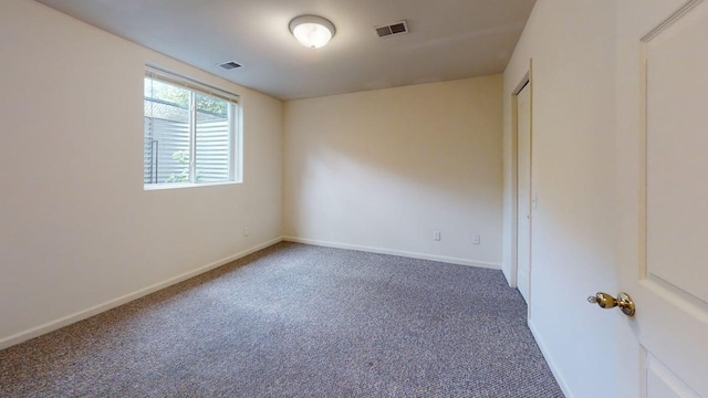 carpeted empty room featuring visible vents and baseboards
