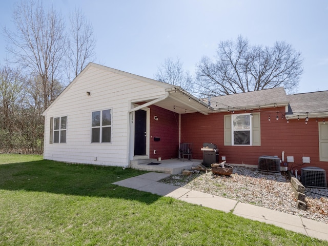 view of front of property with a patio area, central AC, and a front yard
