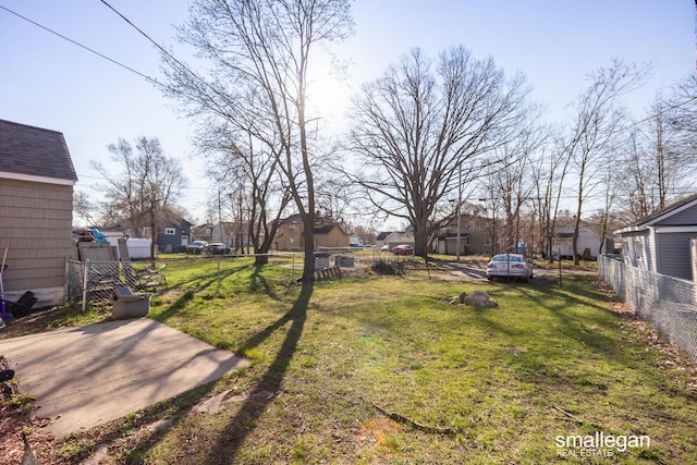 view of yard featuring fence and a residential view