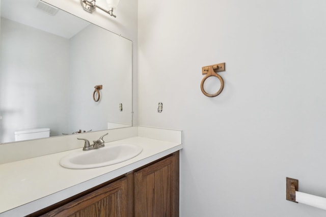 4658 White Pine Ct, Ypsilanti, MI 48197 - bathroom featuring toilet, vanity, and visible vents