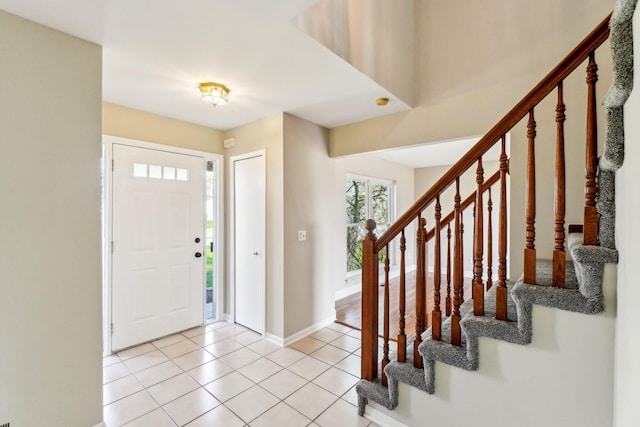 4658 White Pine Ct, Ypsilanti, MI 48197 - entryway featuring light tile patterned floors, baseboards, and stairway