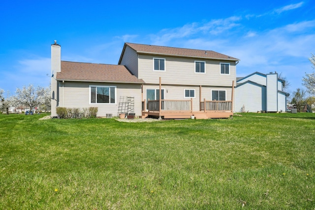 4658 White Pine Ct, Ypsilanti, MI 48197 - rear view of house featuring a lawn, a shingled roof, a chimney, and a deck