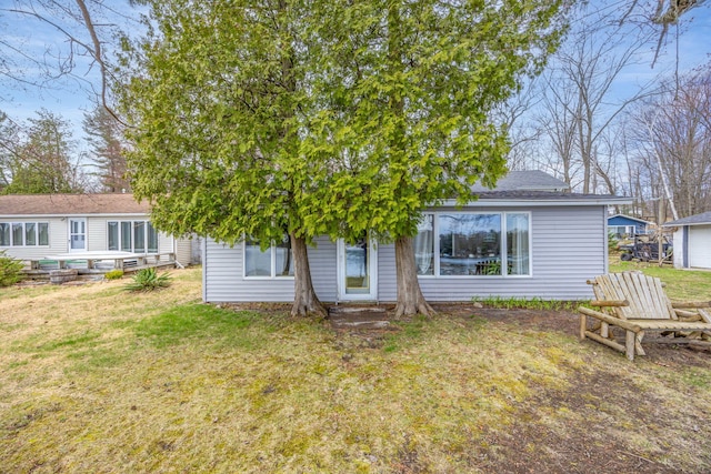 rear view of property with a yard