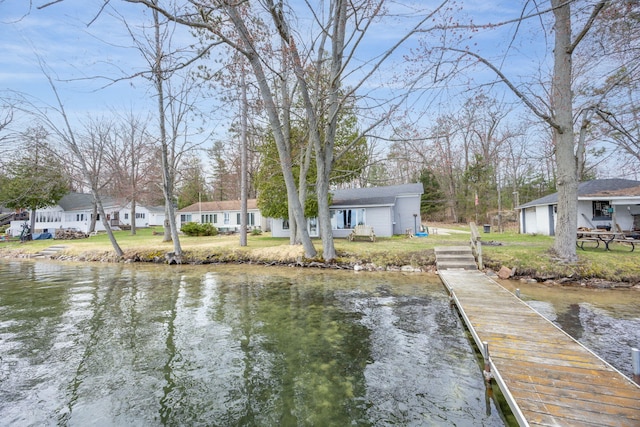 dock area featuring a lawn, a water view, and a residential view
