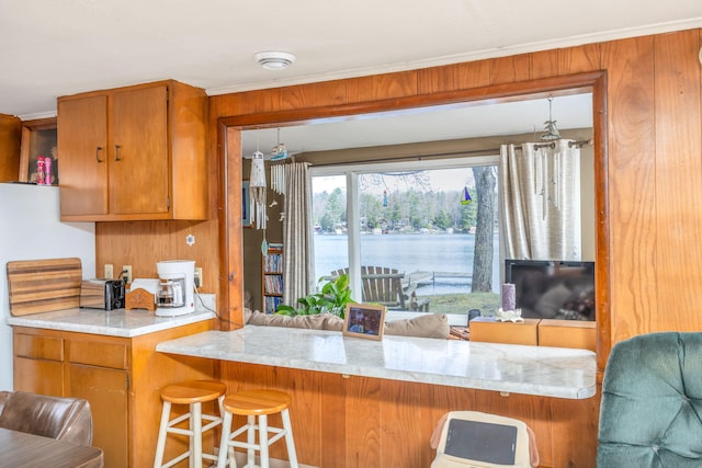 kitchen with brown cabinetry and a kitchen bar