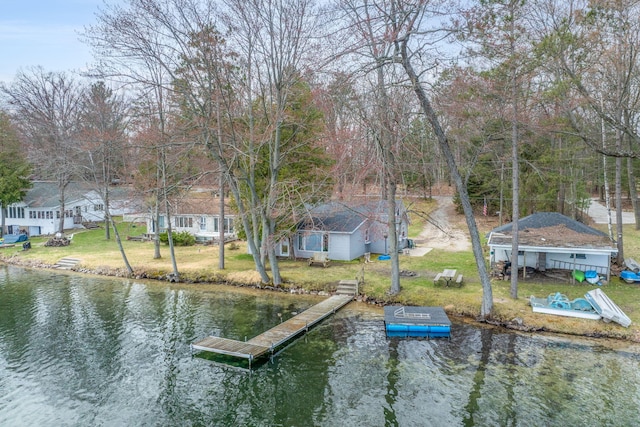 view of dock featuring a yard and a water view