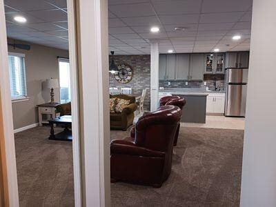 935 Stony Lake Ct, Oxford, MI 48371 - living room featuring recessed lighting, a paneled ceiling, and light carpet