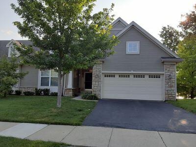 935 Stony Lake Ct, Oxford, MI 48371 - view of front of property featuring stone siding, a front lawn, driveway, and a garage