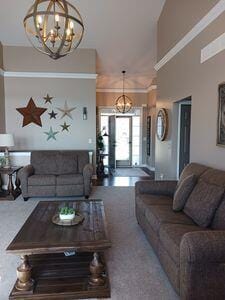 935 Stony Lake Ct, Oxford, MI 48371 - living room with a chandelier, carpet flooring, and a towering ceiling