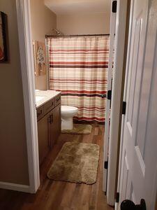 935 Stony Lake Ct, Oxford, MI 48371 - full bathroom featuring toilet, vanity, wood finished floors, and curtained shower