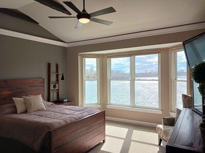 935 Stony Lake Ct, Oxford, MI 48371 - carpeted bedroom with ceiling fan, lofted ceiling, ornamental molding, and multiple windows