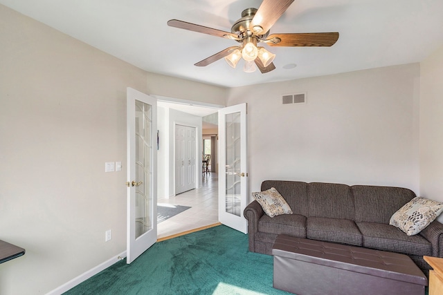 living area featuring ceiling fan, french doors, carpet, baseboards, and visible vents