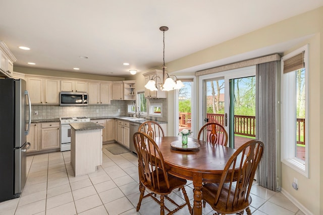 dining space featuring an inviting chandelier, recessed lighting, and light tile patterned floors