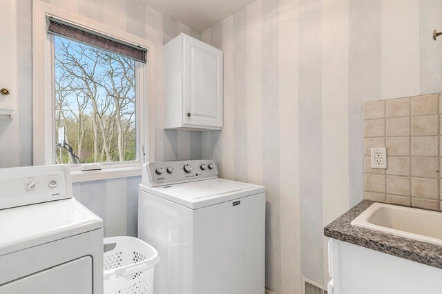 laundry room featuring cabinet space, independent washer and dryer, and visible vents