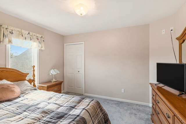 bedroom featuring baseboards and light colored carpet