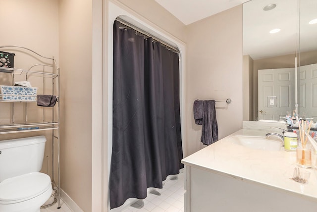 bathroom featuring toilet, recessed lighting, and vanity
