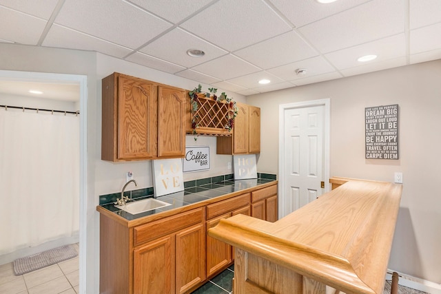 kitchen featuring a sink, tile patterned floors, recessed lighting, and a paneled ceiling