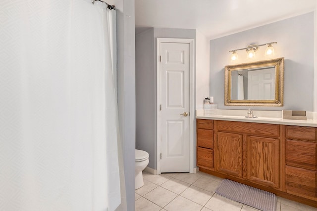 bathroom with toilet, tile patterned floors, and vanity