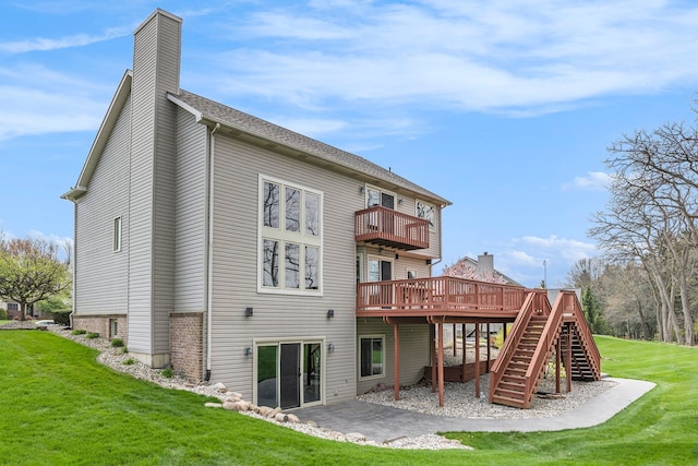 back of house with a lawn, a chimney, a balcony, and stairway