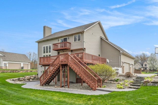 back of house with stairs, an attached garage, a wooden deck, a chimney, and a lawn