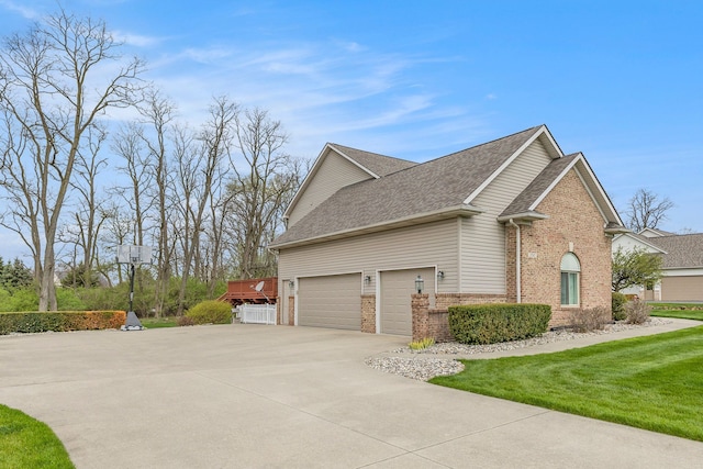 view of home's exterior with a lawn, brick siding, driveway, and a shingled roof