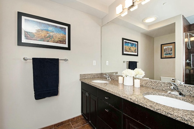27 Library St NE Unit 601, Grand Rapids, MI 49503 - bathroom with double vanity, toilet, tile patterned floors, a shower, and baseboards
