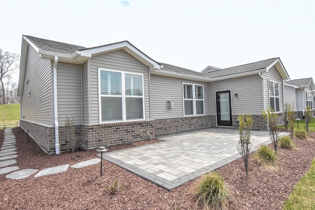 4336 Silica Dr, Lake Orion, MI 48359 - back of house with fence, roof with shingles, a patio, and brick siding
