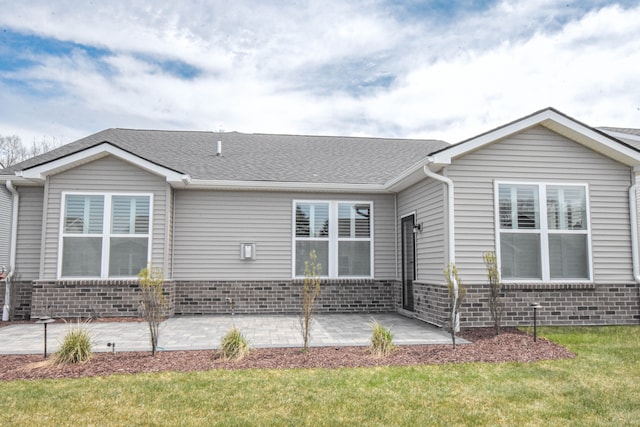4336 Silica Dr, Lake Orion, MI 48359 - view of front of house with brick siding, roof with shingles, a front lawn, and a patio area