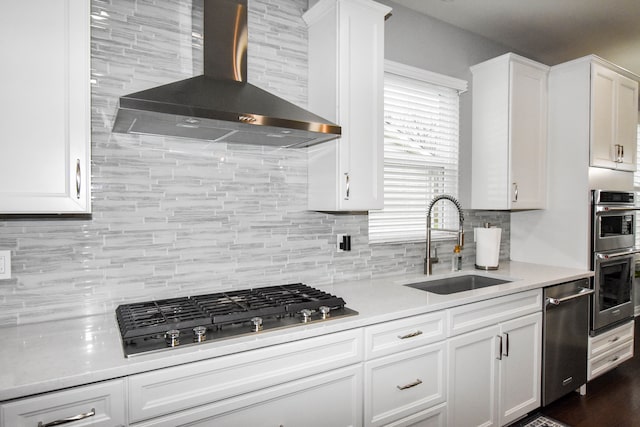 4336 Silica Dr, Lake Orion, MI 48359 - kitchen with a sink, stainless steel appliances, wall chimney exhaust hood, white cabinetry, and light countertops