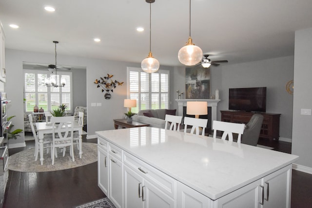 4336 Silica Dr, Lake Orion, MI 48359 - kitchen with ceiling fan, baseboards, white cabinetry, light countertops, and open floor plan