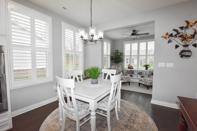 4336 Silica Dr, Lake Orion, MI 48359 - dining space featuring ceiling fan with notable chandelier, visible vents, baseboards, and dark wood finished floors