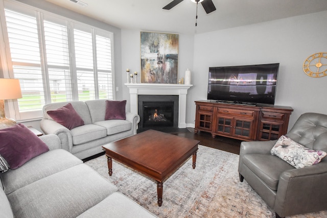4336 Silica Dr, Lake Orion, MI 48359 - living room featuring a healthy amount of sunlight, wood finished floors, a ceiling fan, and a fireplace with flush hearth