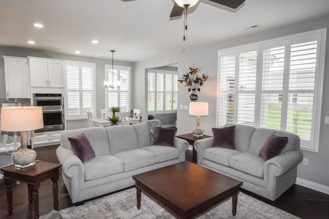 4336 Silica Dr, Lake Orion, MI 48359 - living room featuring baseboards, recessed lighting, wood finished floors, and ceiling fan with notable chandelier