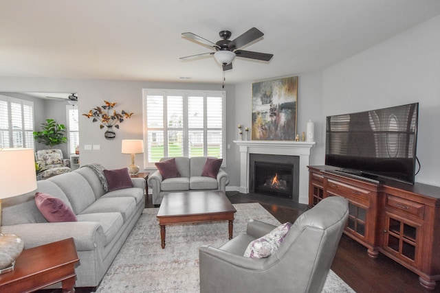 4336 Silica Dr, Lake Orion, MI 48359 - living room with plenty of natural light, a ceiling fan, a fireplace with flush hearth, and dark wood-type flooring