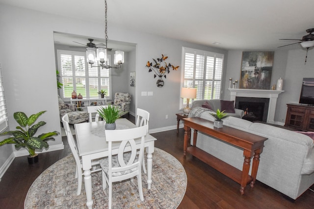 4336 Silica Dr, Lake Orion, MI 48359 - dining room featuring a wealth of natural light, ceiling fan with notable chandelier, and dark wood-style flooring