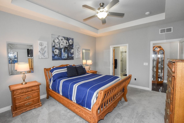 4336 Silica Dr, Lake Orion, MI 48359 - carpeted bedroom featuring a tray ceiling, a ceiling fan, visible vents, baseboards, and ensuite bathroom