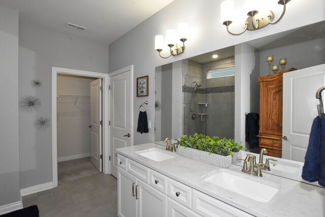 4336 Silica Dr, Lake Orion, MI 48359 - full bath with visible vents, a tile shower, double vanity, and a sink